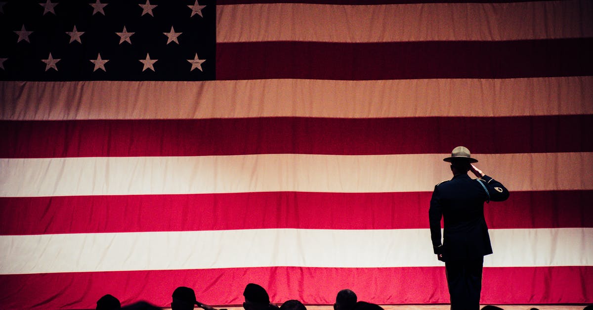 How can I extend my stay in America for 6 more days? - Man Standing On Stage Facing An American Flag How can I extend my stay in America for 6 more days? - Man Standing On Stage Facing An American Flag