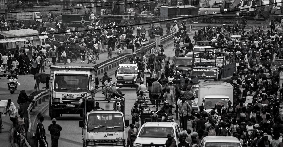 How can I find Turkish truck stops in Greece? - Crowd and cars on road in city How can I find Turkish truck stops in Greece? - Crowd and cars on road in city