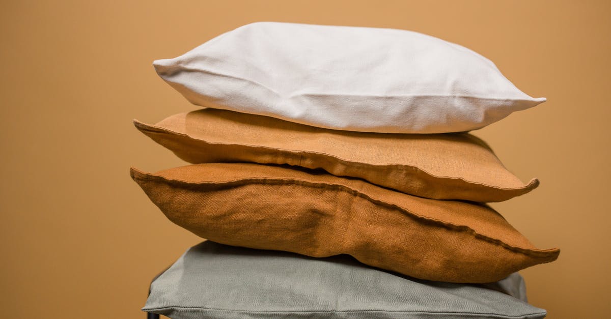 How can I get a different seat after boarding a flight? - Stack of different colorful pillows folded and placed in stack on chair isolated on dark beige background How can I get a different seat after boarding a flight? - Stack of different colorful pillows folded and placed in stack on chair isolated on dark beige background