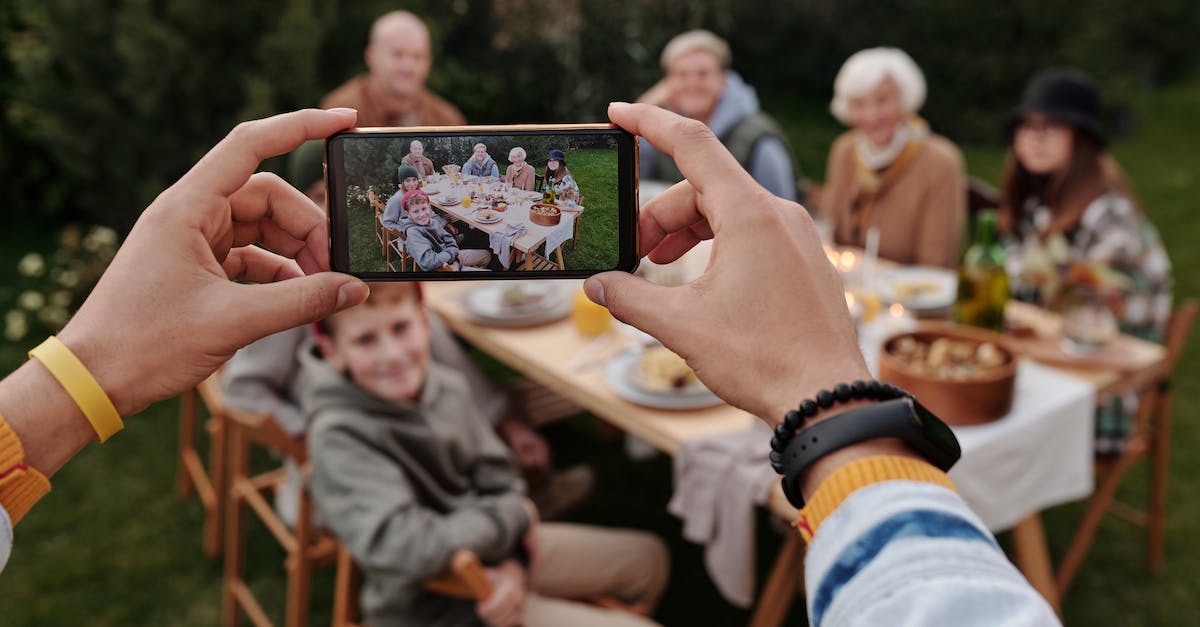 How can I get a US passport photo mailed to me based on an existing digital picture? - Unrecognizable person taking photo of family dinner on smartphone How can I get a US passport photo mailed to me based on an existing digital picture? - Unrecognizable person taking photo of family dinner on smartphone
