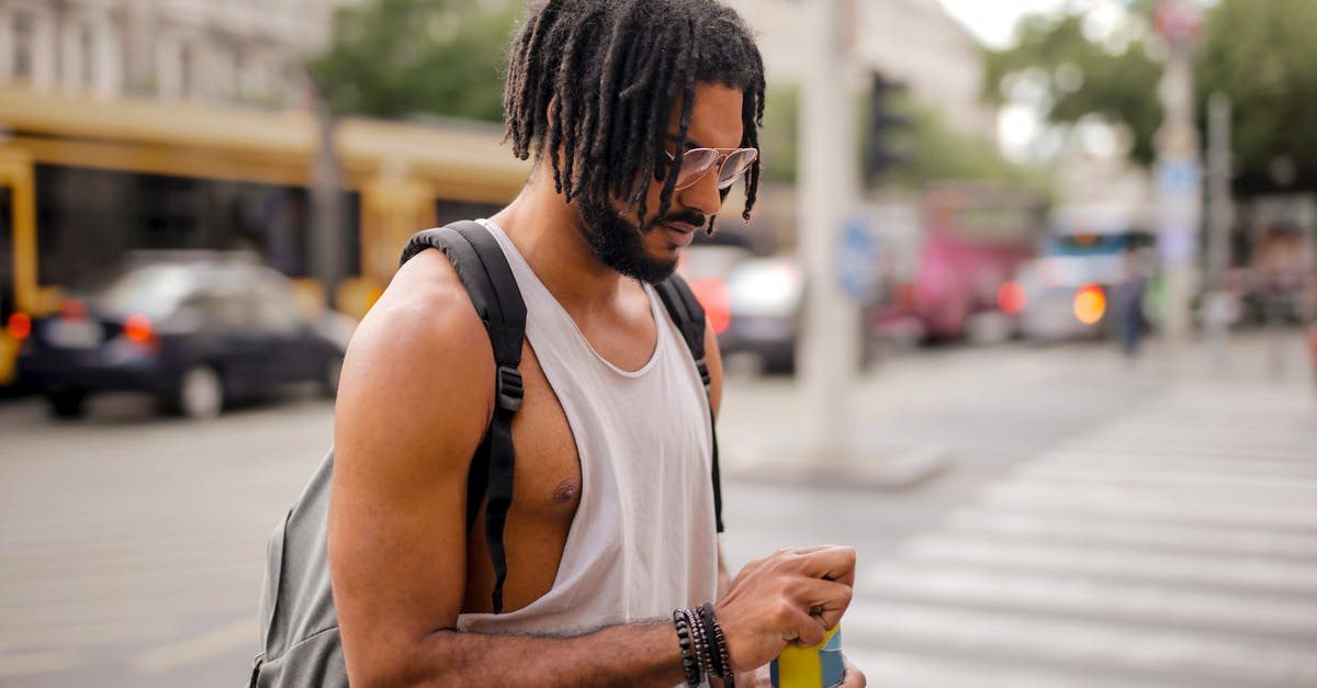 How can I know if my car was added to SENTRI? - Confident adult Hispanic male traveler in sunglasses and casual clothes with backpack opening can of drink while walking along pavement against blurred cars driving along street and empty crosswalk in downtown How can I know if my car was added to SENTRI? - Confident adult Hispanic male traveler in sunglasses and casual clothes with backpack opening can of drink while walking along pavement against blurred cars driving along street and empty crosswalk in downtown