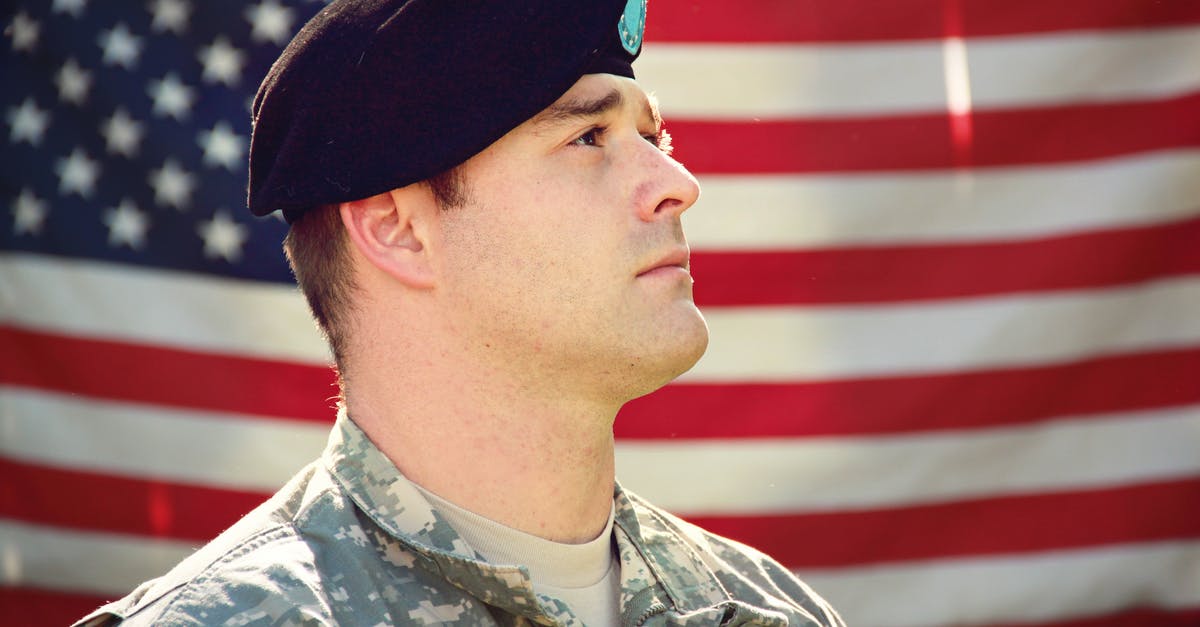How can I make American airlines honor their travel voucher? - Man Wearing Combat Hat And Top Looking Up Near Flag Of America How can I make American airlines honor their travel voucher? - Man Wearing Combat Hat And Top Looking Up Near Flag Of America