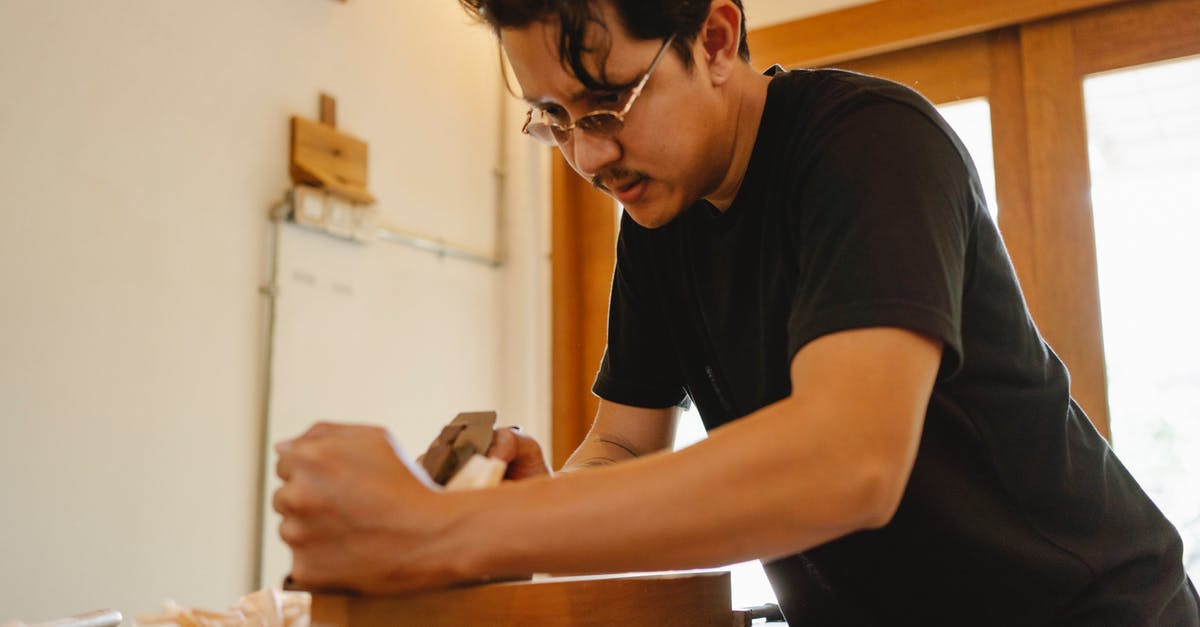 How can I make sure I never board an airplane made by a particular manufacturer? - Focused ethnic joiner planing wood plank