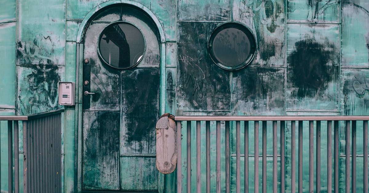 How can I open and reset the combination lock on my suitcase, I have forgotten the combination [duplicate] - Old shabby cabin with combination lock and round windows