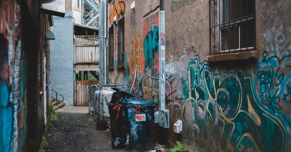 How can I proceed regarding a possibly-lost letter when travelling? - Garbage can on narrow street between aged houses with graffiti on shabby walls in town How can I proceed regarding a possibly-lost letter when travelling? - Garbage can on narrow street between aged houses with graffiti on shabby walls in town