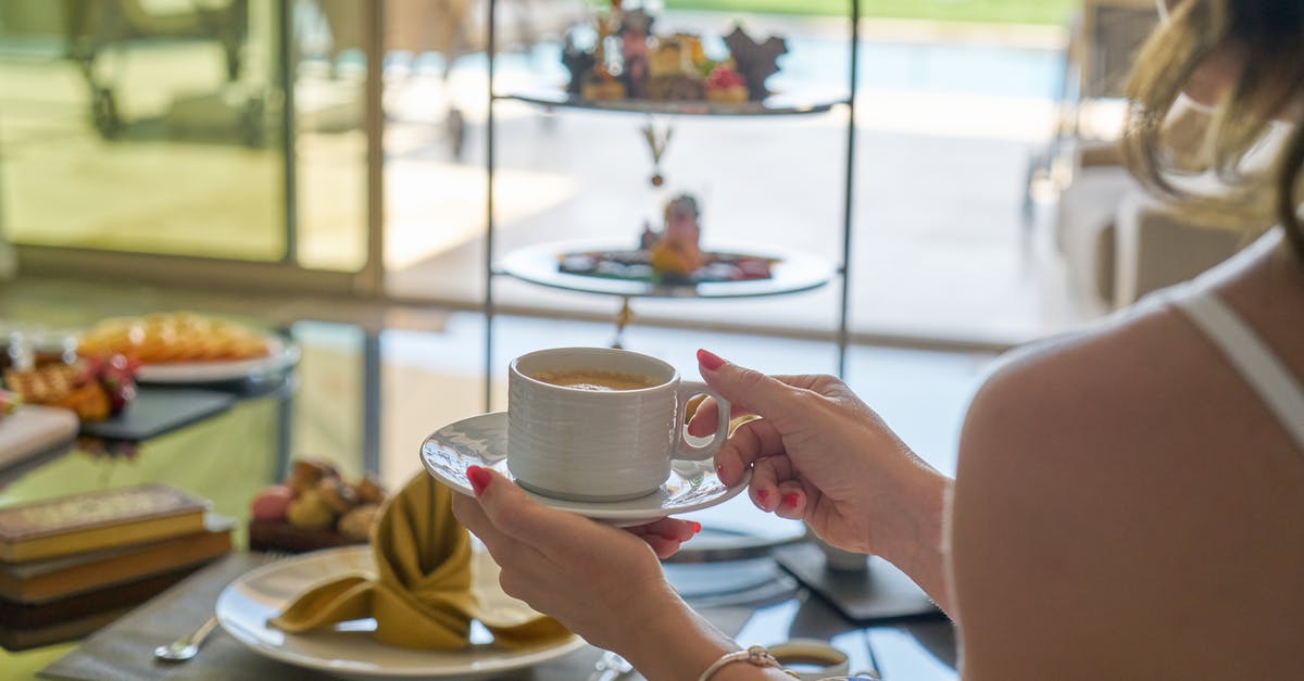 How can I reliably make myself a cup of coffee in my hotel room that doesn't suck? - Woman Holding A Cup Of Coffee How can I reliably make myself a cup of coffee in my hotel room that doesn't suck? - Woman Holding A Cup Of Coffee