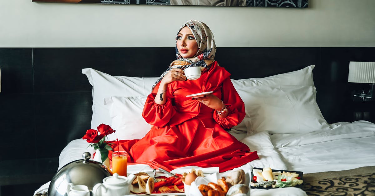 How can I reliably make myself a cup of coffee in my hotel room that doesn't suck? - Woman Wearing Red Gown Holding White Ceramic Cup and Saucer How can I reliably make myself a cup of coffee in my hotel room that doesn't suck? - Woman Wearing Red Gown Holding White Ceramic Cup and Saucer