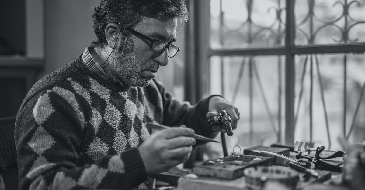 How can I repair my old and expired passport? - Grayscale Photo of Man Holding Tools How can I repair my old and expired passport? - Grayscale Photo of Man Holding Tools