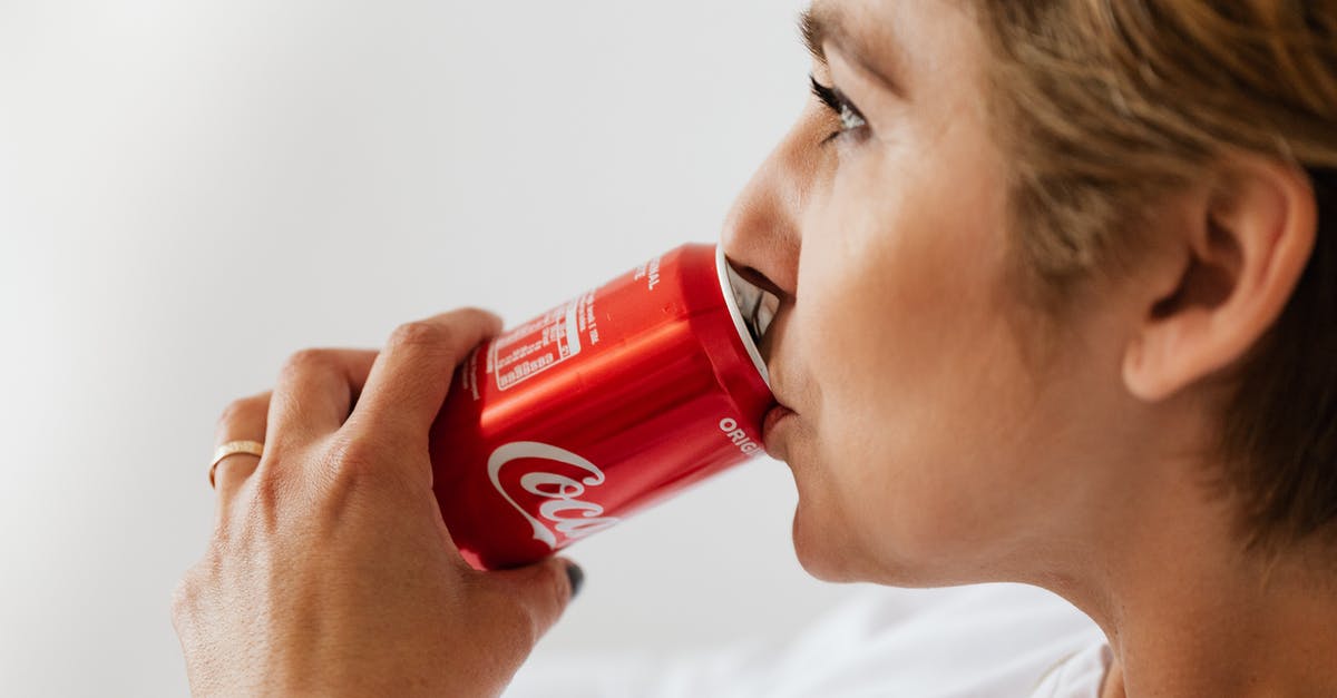 How can I see the Berlin Wall? - Side view of crop wistful female in casual wear and gold ring enjoying coke from red can while sitting near white wall and looking away How can I see the Berlin Wall? - Side view of crop wistful female in casual wear and gold ring enjoying coke from red can while sitting near white wall and looking away