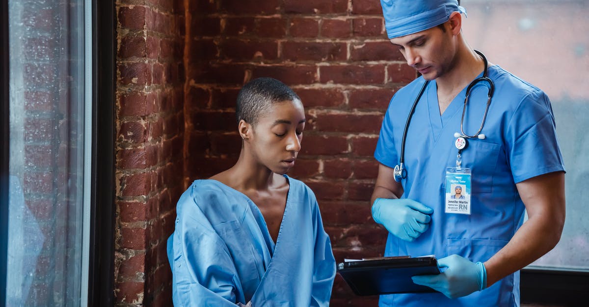 How can I show that I have enough funds to support myself during my stay? - Doctor showing diagnosis to black woman patient in hallway of clinic
