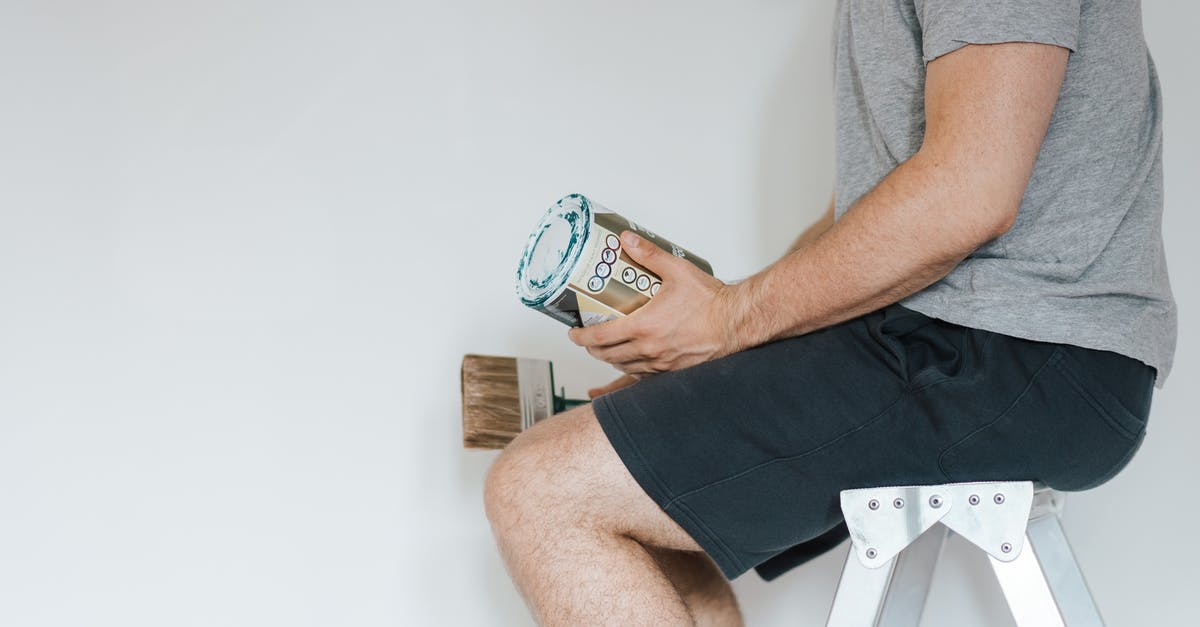 How can I use my new Miles & More membership? - Side view of crop anonymous male with professional brush and can of paint near white wall in house How can I use my new Miles & More membership? - Side view of crop anonymous male with professional brush and can of paint near white wall in house