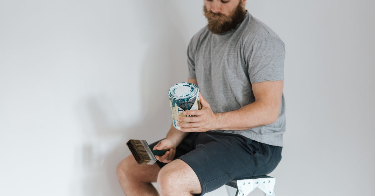 How can I use my new Miles & More membership? - Crop hipster man with can on paint on ladder How can I use my new Miles & More membership? - Crop hipster man with can on paint on ladder