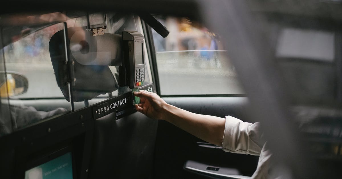 How can I use Ola Cabs without an Indian credit/debit card? - Side view of crop faceless male passenger sitting on backseat and using credit card reader to pay for trip in taxi How can I use Ola Cabs without an Indian credit/debit card? - Side view of crop faceless male passenger sitting on backseat and using credit card reader to pay for trip in taxi