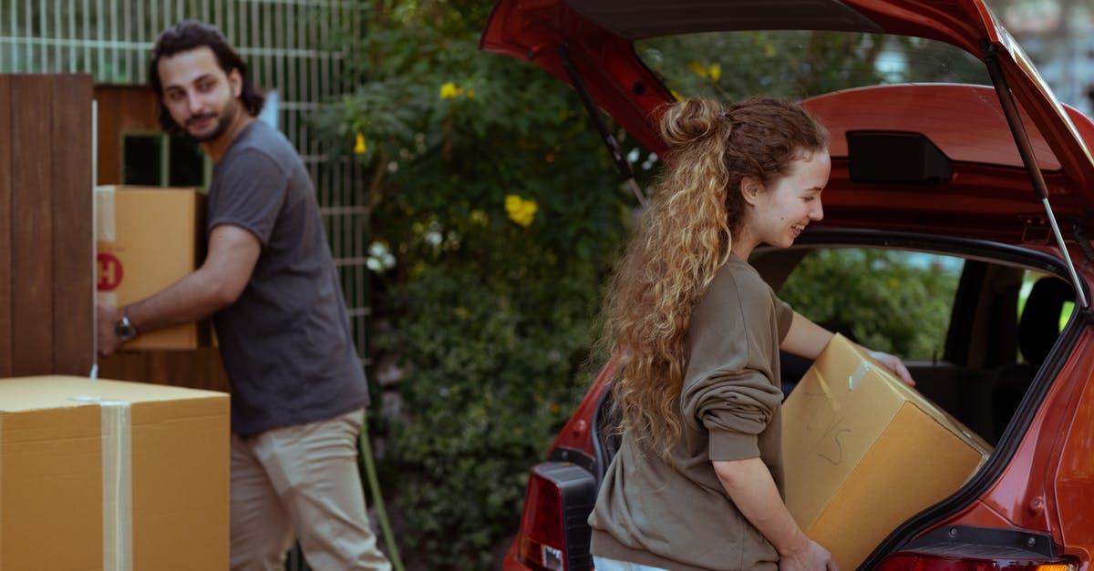 How can my Thai wife get a UK visa? - Couple getting carton boxes out of red car while relocating in new home How can my Thai wife get a UK visa? - Couple getting carton boxes out of red car while relocating in new home