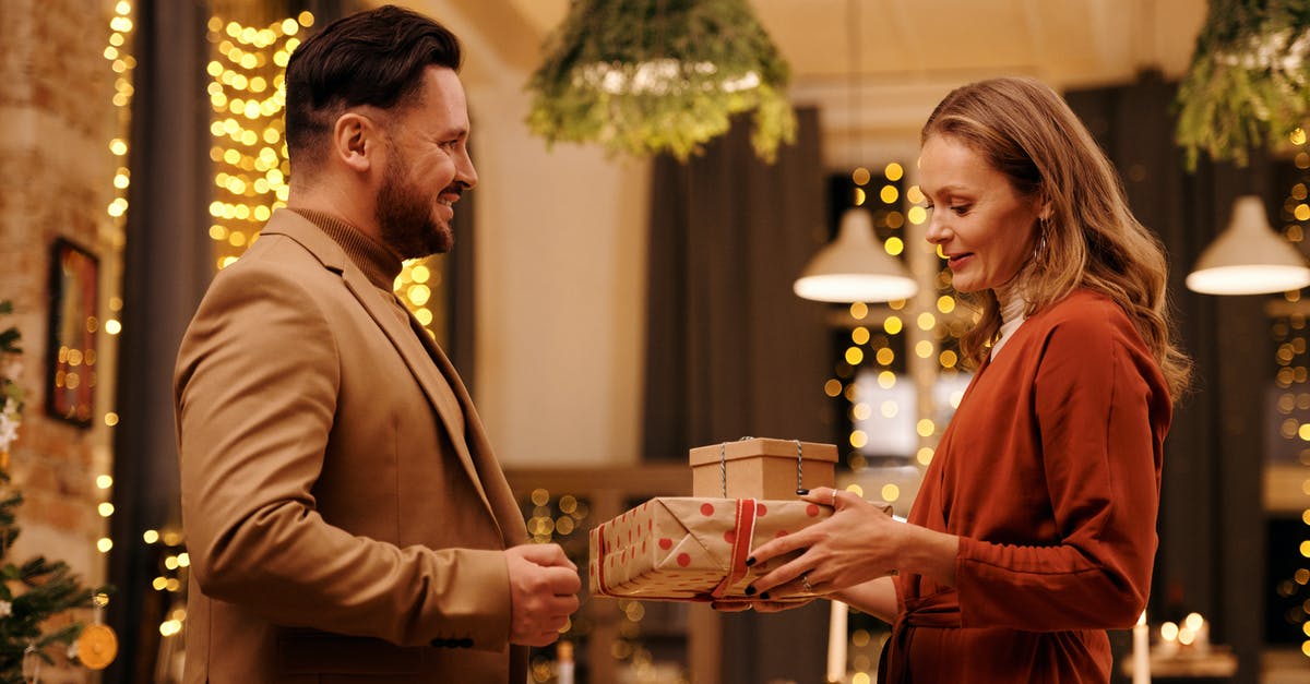 How can my Thai wife get a UK visa? - Woman Giving Christmas Presents to Her Husband How can my Thai wife get a UK visa? - Woman Giving Christmas Presents to Her Husband