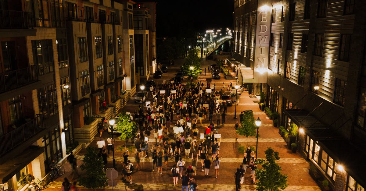 How can Singaporeans studying in a Western country protect themselves from racist hate crime? [closed] - Group of people gathering together at protest