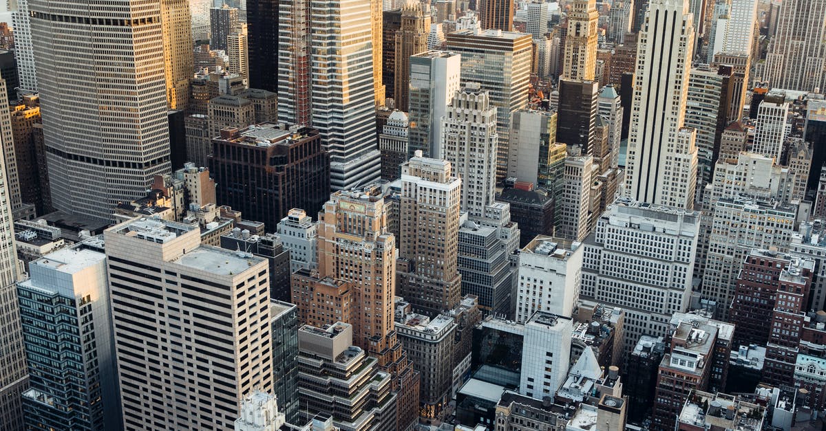 How can someone go USA if she is not working and does not have property in india? [closed] - Residential and commerce buildings placed in downtown of megapolis