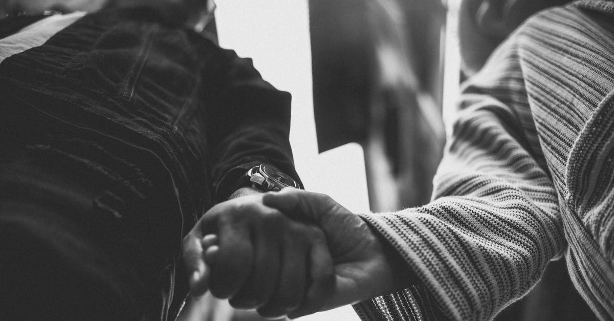 How can two people travel/survive cheaply for two months between housing contracts? [closed] - Grayscale Photo of Man in Black Leather Jacket