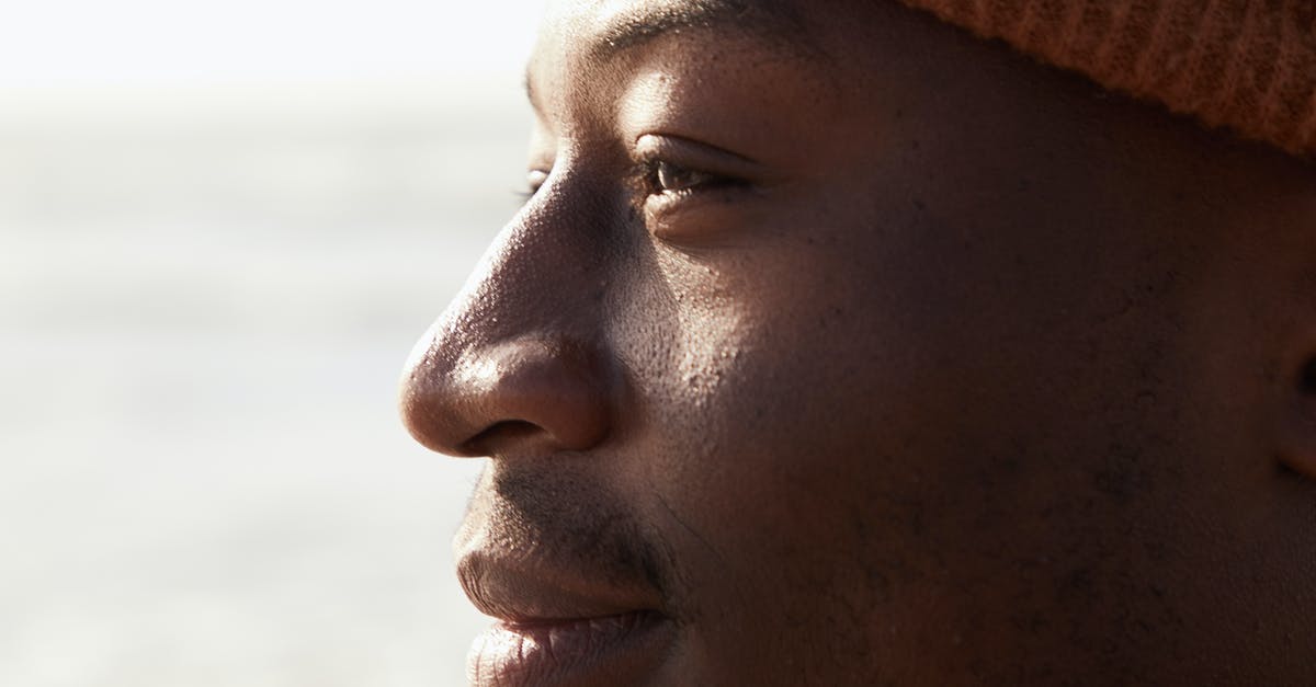 How can you enjoy nature, when it looks better in photographs than in person? [closed] - Crop contemplative young ethnic man in sunlight