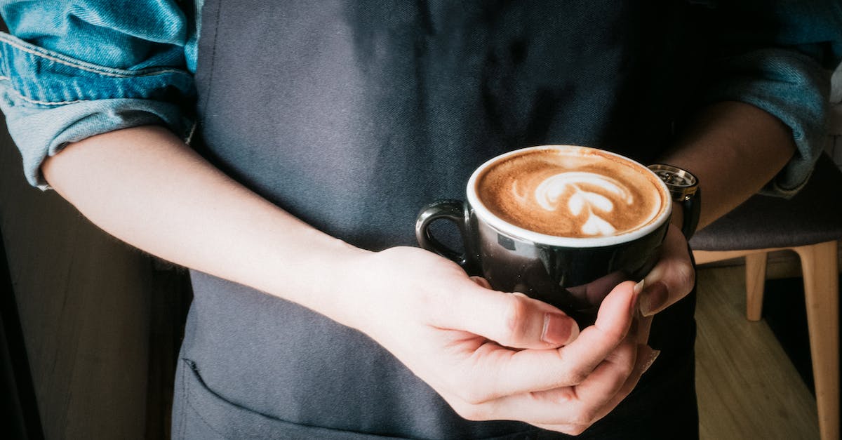 How common is it to find cappuccino in Thailand's coffee shops? - Woman Holding Mug of Cappuccino How common is it to find cappuccino in Thailand's coffee shops? - Woman Holding Mug of Cappuccino