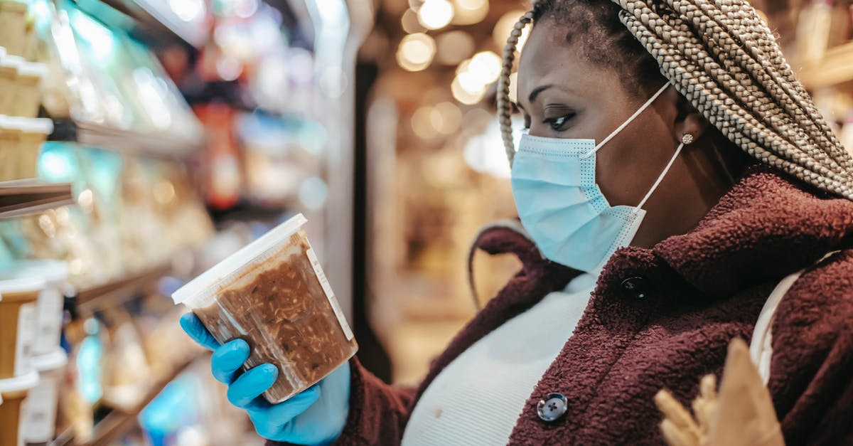 How do airports check incoming goods [closed] - Black woman checking ingredients and manufacturing date of product
