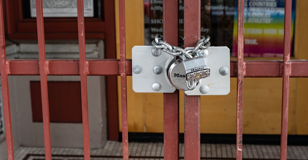 How do door locks work in South America? - Red Metal Gate With Padlock