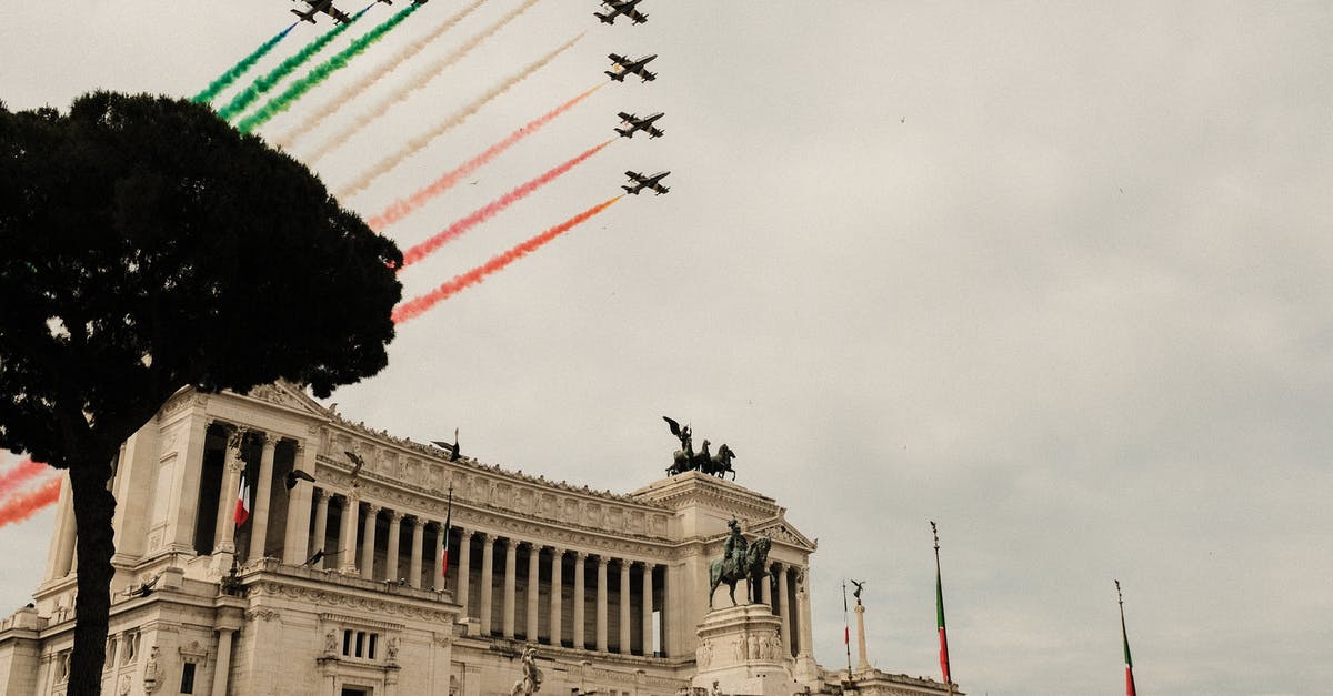 How do hotels choose which flag to fly over the entrance? - Air show above Victor Emmanuel Monument with sculptures in city How do hotels choose which flag to fly over the entrance? - Air show above Victor Emmanuel Monument with sculptures in city