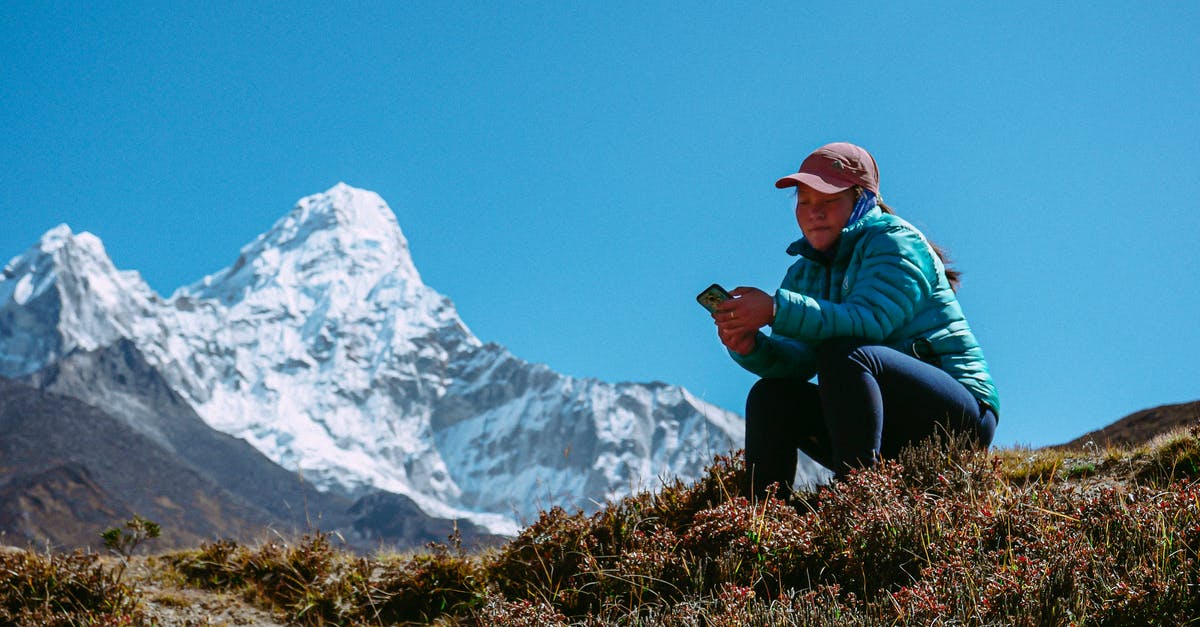How do I apply for a tourist visa for Paris? [closed] - Tourist Girl Sitting on Mountain Meadow with Phone in Hand