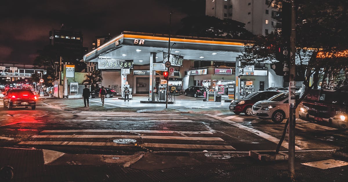 How do I book flights Boston area to St. Thomas to Seattle to Boston area? [duplicate] - Cars driving down asphalt busy roadway with crossing near modern illuminated gas station