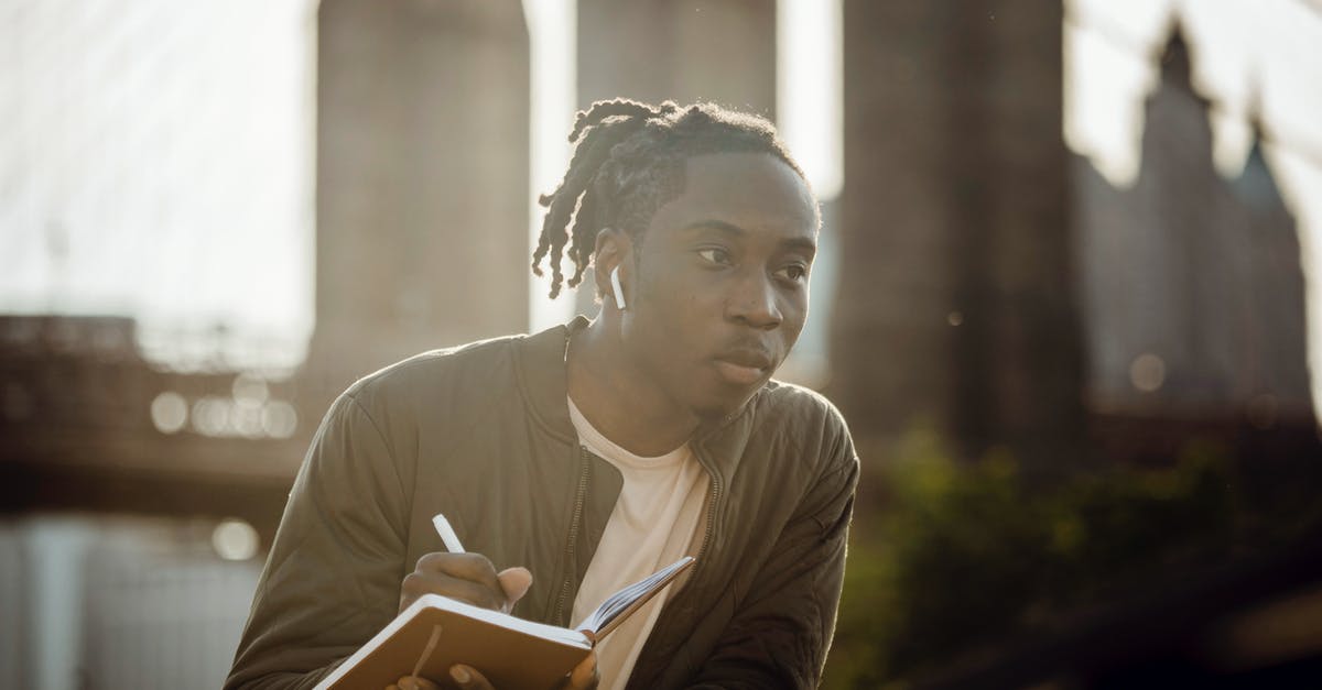How do I create all-inclusive travel packages for a wedding? - Pensive black man drawing picture in notebook while standing on riverbank How do I create all-inclusive travel packages for a wedding? - Pensive black man drawing picture in notebook while standing on riverbank
