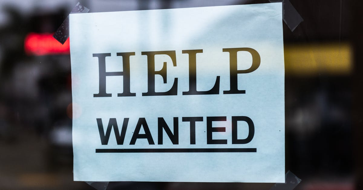 How do I find an immigration lawyer/solicitor to help with my UK Visa application? - Help Wanted Sign on Glass
