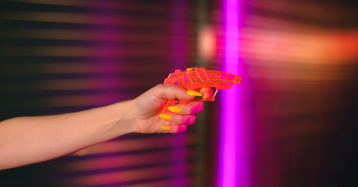 How do I find out what areas to avoid to minimize an attack like the murders of the hikers Jespersen and Ueland in Morocco? - Crop anonymous female with manicured hand pointing toy gun against neon lights in dark studio How do I find out what areas to avoid to minimize an attack like the murders of the hikers Jespersen and Ueland in Morocco? - Crop anonymous female with manicured hand pointing toy gun against neon lights in dark studio