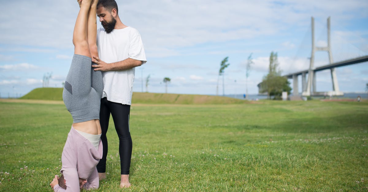 How do I find out when advance tickets become available for GB trains? - Woman in White Shirt and Black Leggings Standing on Green Grass Field