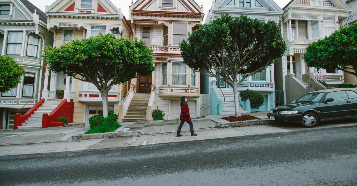 How do I find out whether walking is allowed on San Francisco restricted roads? - Woman Walking Toward Black Sedan Parked In Front of Colorful Houses How do I find out whether walking is allowed on San Francisco restricted roads? - Woman Walking Toward Black Sedan Parked In Front of Colorful Houses