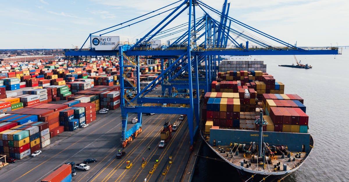 How do I get from Cairo Airport to Port Said with 2 large 20kg bags? - Cargo ship unloading colorful containers in port How do I get from Cairo Airport to Port Said with 2 large 20kg bags? - Cargo ship unloading colorful containers in port