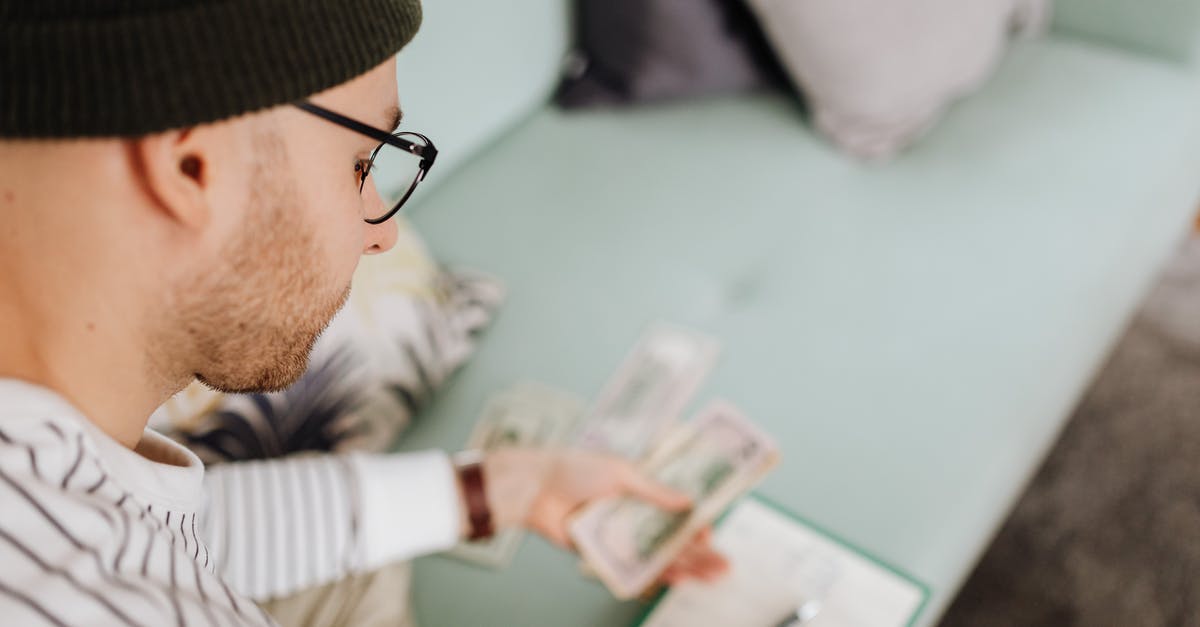 How do I keep my cash safe in Japan? - Man in Black Beanie Hat Holding Money How do I keep my cash safe in Japan? - Man in Black Beanie Hat Holding Money