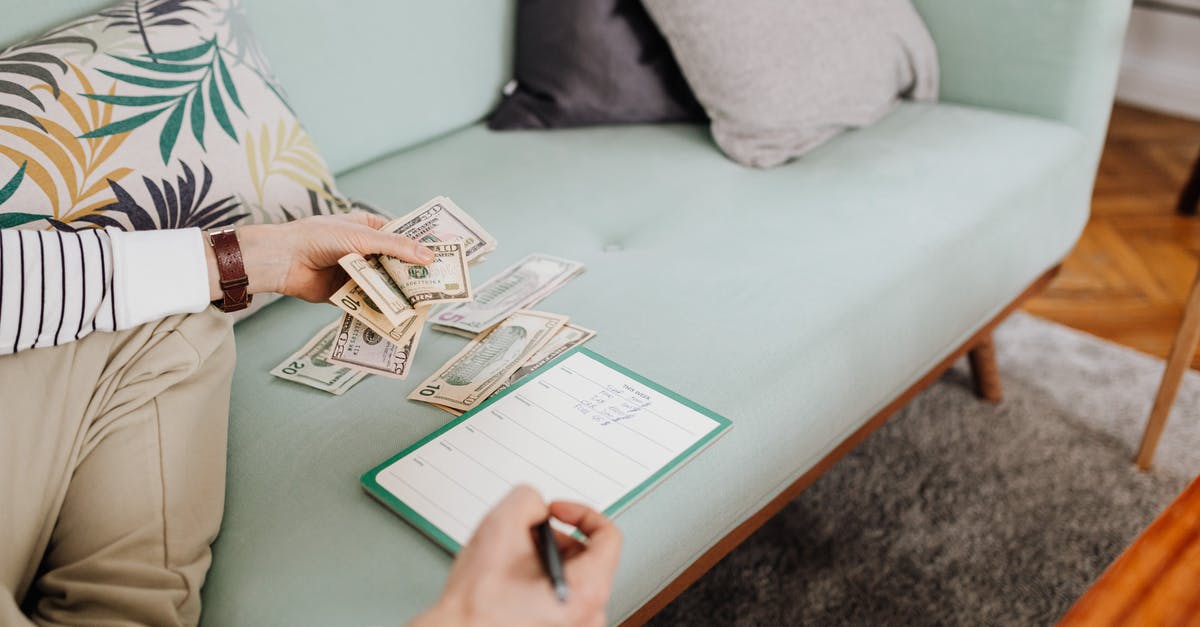 How do I keep my cash safe in Japan? - Person Writing on Paper While Counting His Money How do I keep my cash safe in Japan? - Person Writing on Paper While Counting His Money
