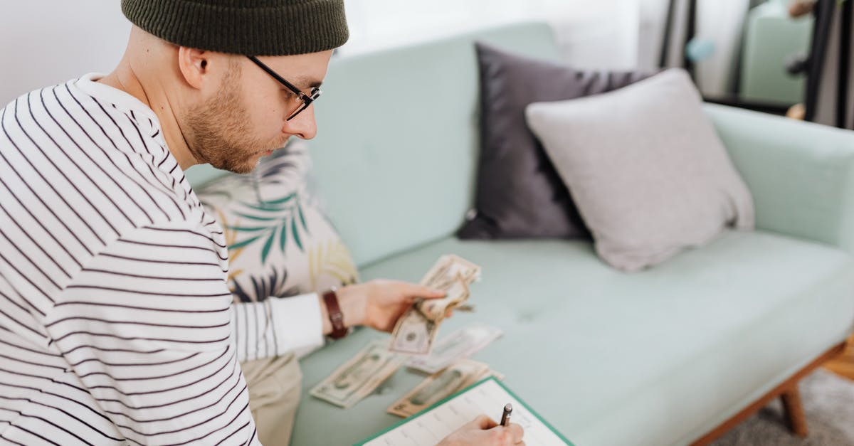 How do I keep my cash safe in Japan? - Man Writing on a Paper While Sitting on Green Couch How do I keep my cash safe in Japan? - Man Writing on a Paper While Sitting on Green Couch
