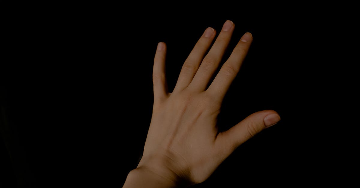How do I tell Spain that I’ve left the EU? - A Persons Left Hand on Black Background How do I tell Spain that I’ve left the EU? - A Persons Left Hand on Black Background