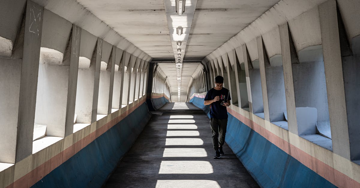 How do I use the Hong Kong-Zhuhai-Macao (HKZM) bridge? - Man Walking Inside a Foot Bridge How do I use the Hong Kong-Zhuhai-Macao (HKZM) bridge? - Man Walking Inside a Foot Bridge