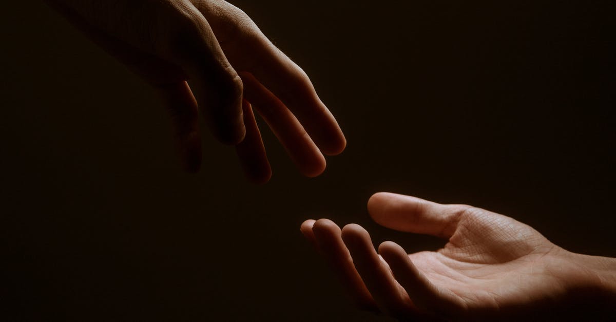 How do the authorities know whether someone reaches a country? - Persons Hand on Black Background