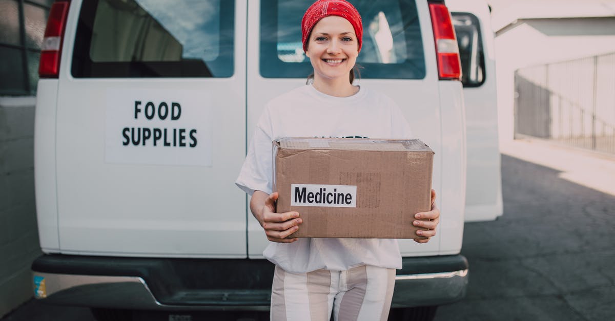 How do travel agents make profit? - Woman Carrying a Medicine Labelled Cardboard Boxes Behind a White Van How do travel agents make profit? - Woman Carrying a Medicine Labelled Cardboard Boxes Behind a White Van