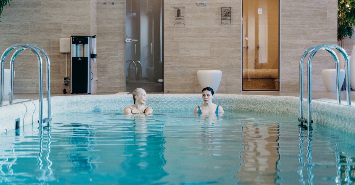 How do you behave in icelandic public swimming pools? - An Elderly Woman with a Young Woman in a Swimming Pool