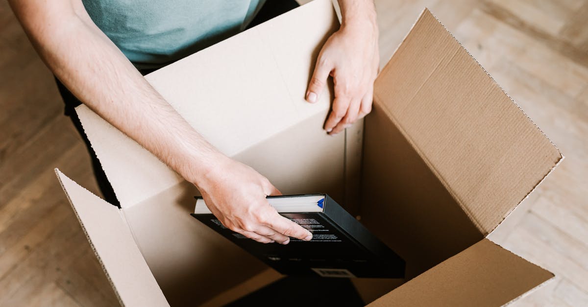 How do you book an Emirates Dubai stopover package (from US/Canada)? - Crop man packing books in carton box How do you book an Emirates Dubai stopover package (from US/Canada)? - Crop man packing books in carton box