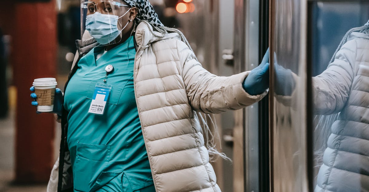 How do you exit Dutch railway stations with an international paper-based ticket? - Thoughtful black nurse in protective mask leaving metro train How do you exit Dutch railway stations with an international paper-based ticket? - Thoughtful black nurse in protective mask leaving metro train