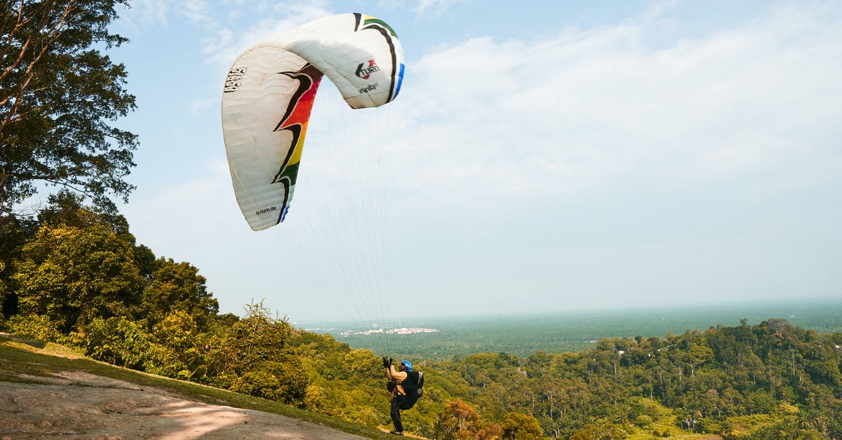How do you get air miles? - Man Holding Onto Parachute How do you get air miles? - Man Holding Onto Parachute