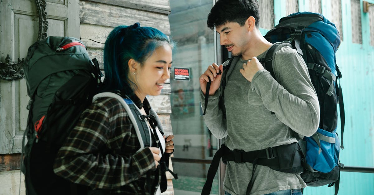 How does free baggage for Frequent Traveler status work? - Multiracial couple of travelers with backpacks How does free baggage for Frequent Traveler status work? - Multiracial couple of travelers with backpacks