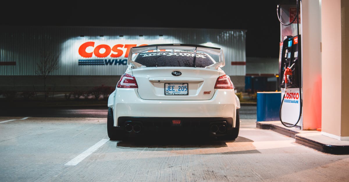 How does one know if a rental car takes diesel or gasoline? - Contemporary white car parked near pump on fuel station at night in city How does one know if a rental car takes diesel or gasoline? - Contemporary white car parked near pump on fuel station at night in city