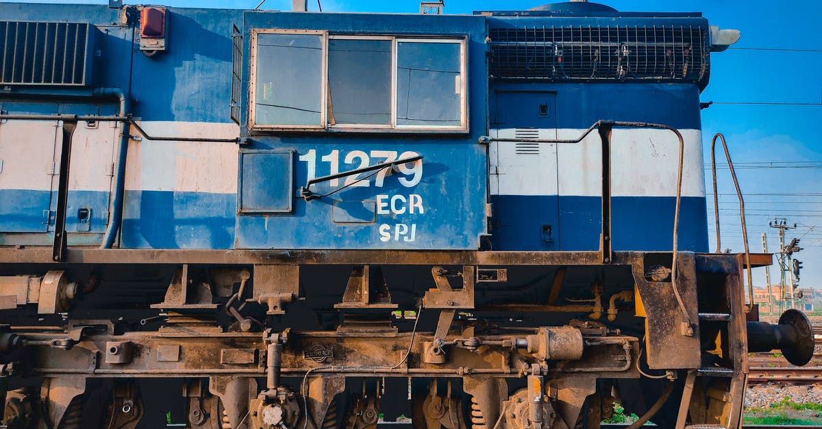 How does one "navigate" by train across Central Europe? [closed] - Blue and Brown Train on Rail Tracks
