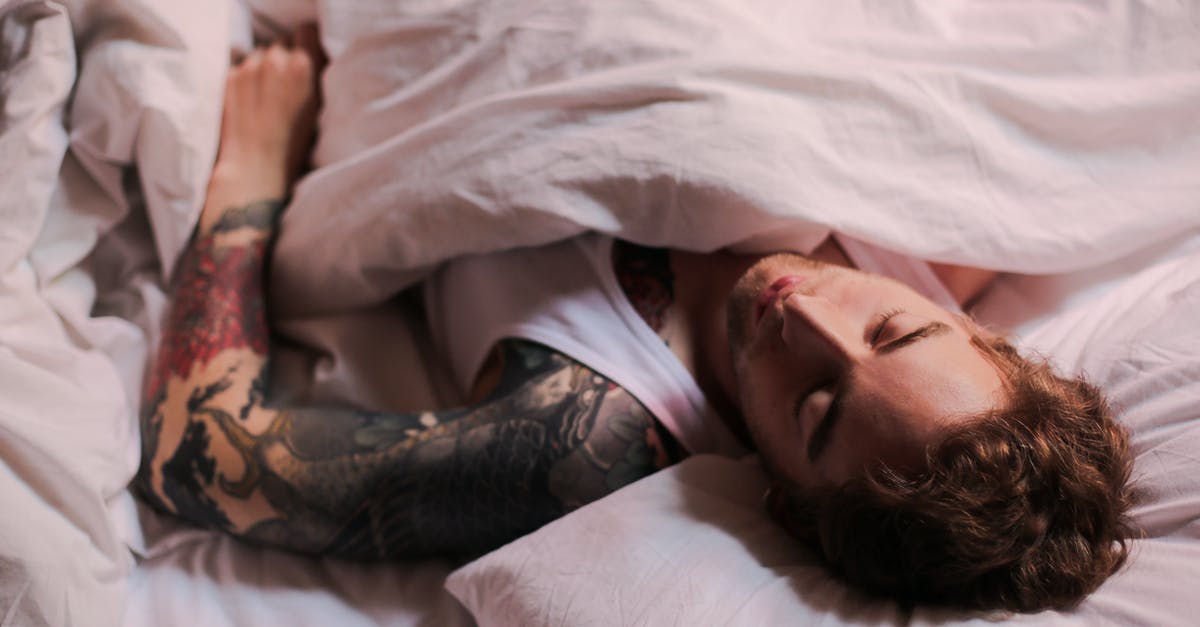 How does one sleep in a sleeper train in Europe? - Woman Lying on Bed With Tattoo on Her Body How does one sleep in a sleeper train in Europe? - Woman Lying on Bed With Tattoo on Her Body